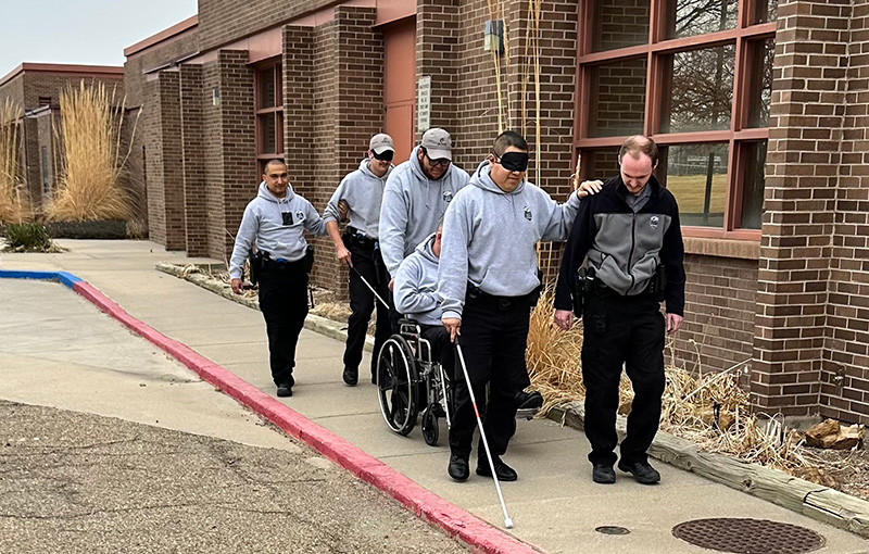 LETA cadets using a walking cane and wheelchair.