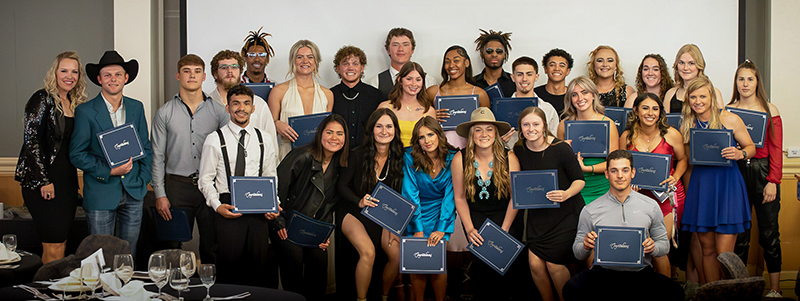 A group of students pose with awards.