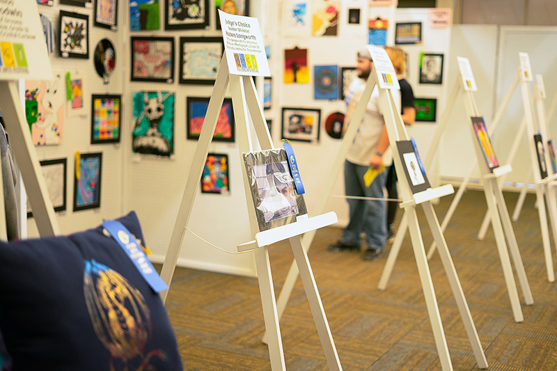 image of student art work on easels and walls.