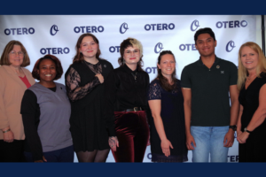 MLT Nursing Students and their instructor stand in front of an "Otero College" branded wall