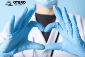 A nurse making a heart shape with their hands