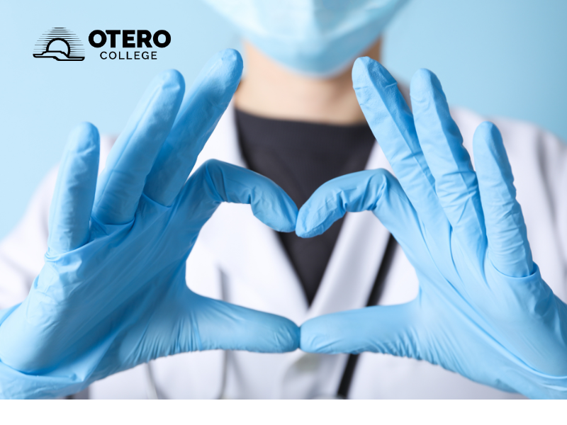 A nurse making a heart shape with their hands